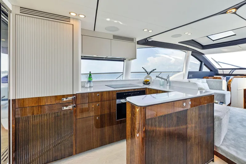  Yacht Photos Pics Luxurious interior of 2024 Fairline Phantom 65 yacht with modern kitchen design.