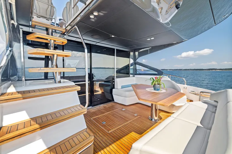  Yacht Photos Pics Luxurious 2024 Fairline Phantom 65 yacht deck with elegant seating and ocean view.