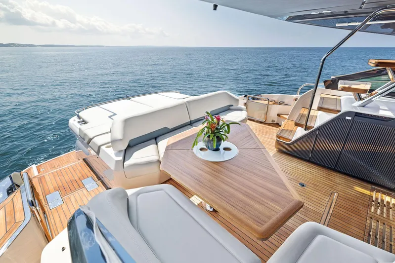  Yacht Photos Pics Luxurious 2024 Fairline Phantom 65 yacht deck with elegant seating and ocean view.