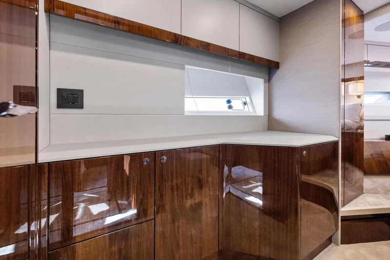  Yacht Photos Pics Luxurious interior of 2024 Fairline Phantom 65 yacht with sleek wood cabinetry.