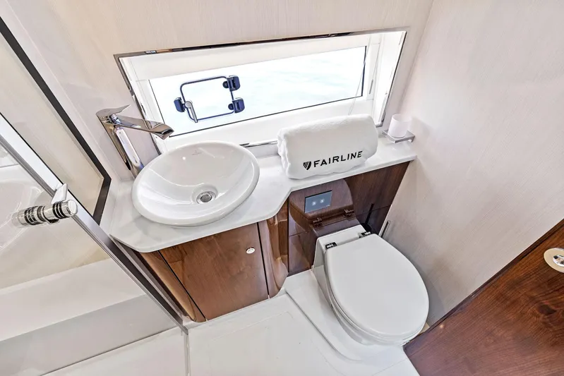  Yacht Photos Pics Luxurious bathroom in 2024 Fairline Phantom 65 yacht with modern fixtures and elegant design.