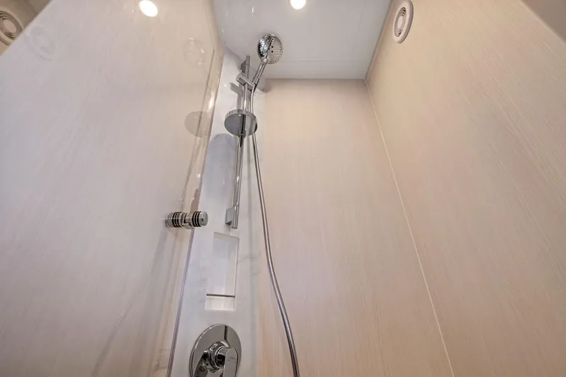  Yacht Photos Pics Luxurious shower in 2024 Fairline Phantom 65 yacht, featuring modern fixtures and elegant design.