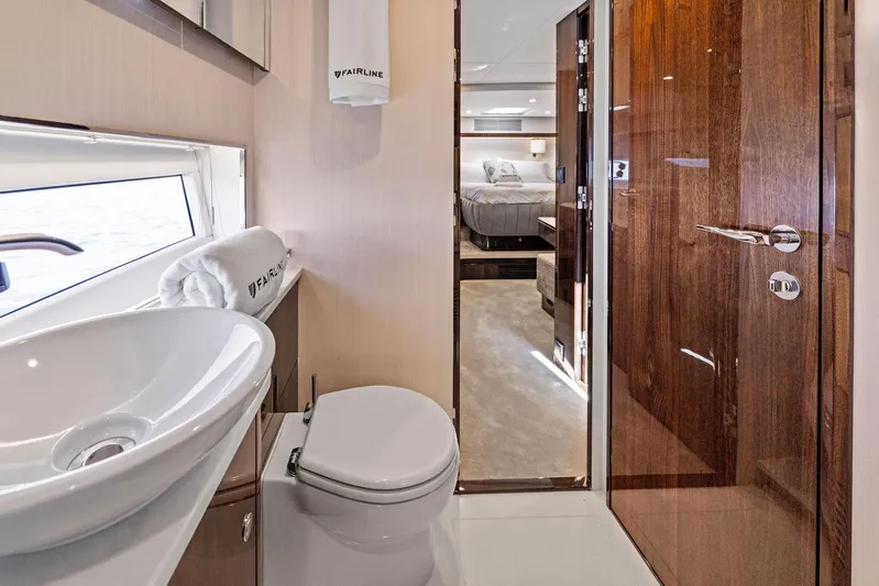  Yacht Photos Pics Luxurious bathroom interior of 2024 Fairline Phantom 65 yacht, featuring modern fixtures and elegant design.