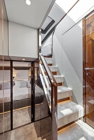  Yacht Photos Pics Luxurious interior of 2024 Fairline Phantom 65 yacht with elegant staircase and modern design.