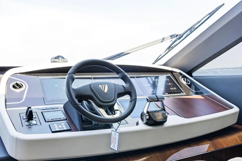  Yacht Photos Pics Helm of 2024 Fairline Phantom 65 yacht with modern controls and steering wheel.