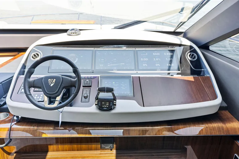  Yacht Photos Pics 2024 Fairline Phantom 65 yacht helm with modern dashboard and steering wheel.
