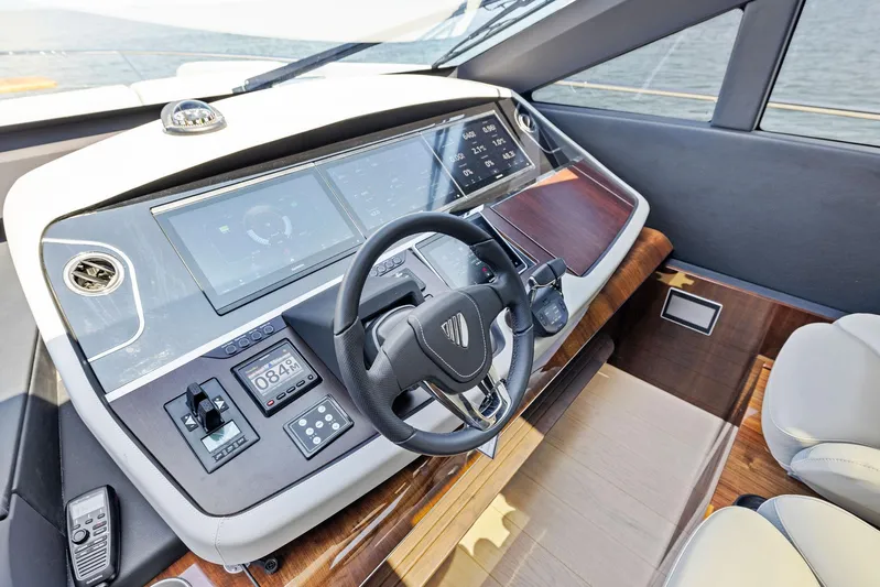  Yacht Photos Pics 2024 Fairline Phantom 65 helm with modern controls and sleek design.