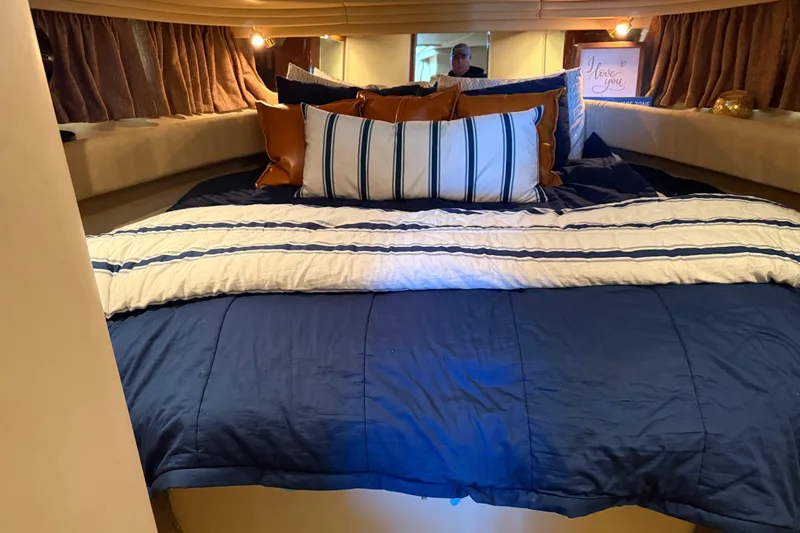 Fox Den Yacht Photos Pics Luxurious cabin interior of 2001 Sea Ray 380 Sundancer with cozy bedding and ambient lighting.