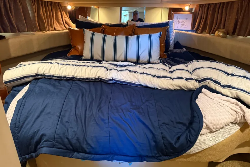 Fox Den Yacht Photos Pics Cozy cabin interior of 2001 Sea Ray 380 Sundancer with plush bedding and pillows.