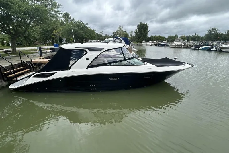  Yacht Photos Pics 2020 Sea Ray 350 SLX boat docked in a marina under cloudy skies.