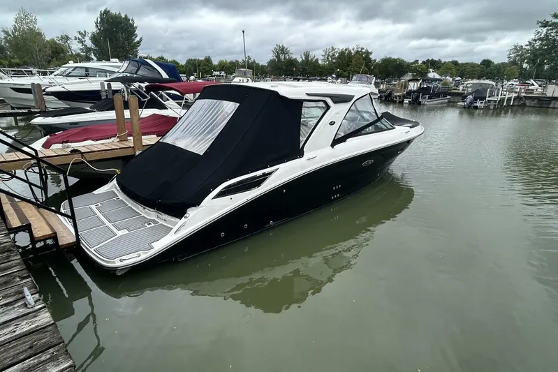  Yacht Photos Pics 2020 Sea Ray 350 SLX boat docked in a marina under cloudy skies.