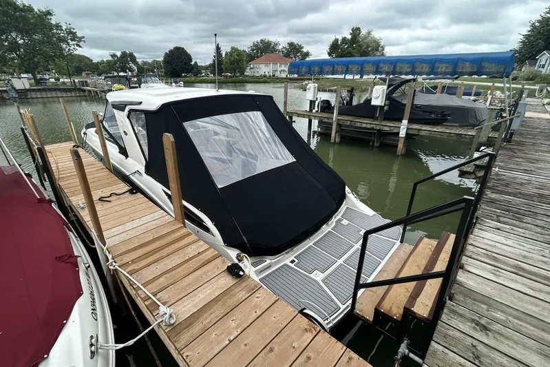  Yacht Photos Pics 2020 Sea Ray 350 SLX docked at a marina, featuring a black canopy.