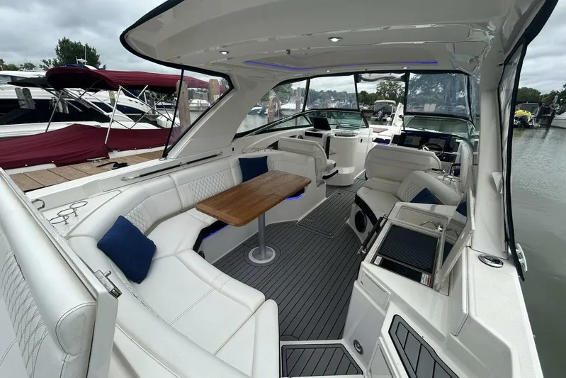  Yacht Photos Pics Luxurious 2020 Sea Ray 350 SLX boat interior with white seating and wooden table.