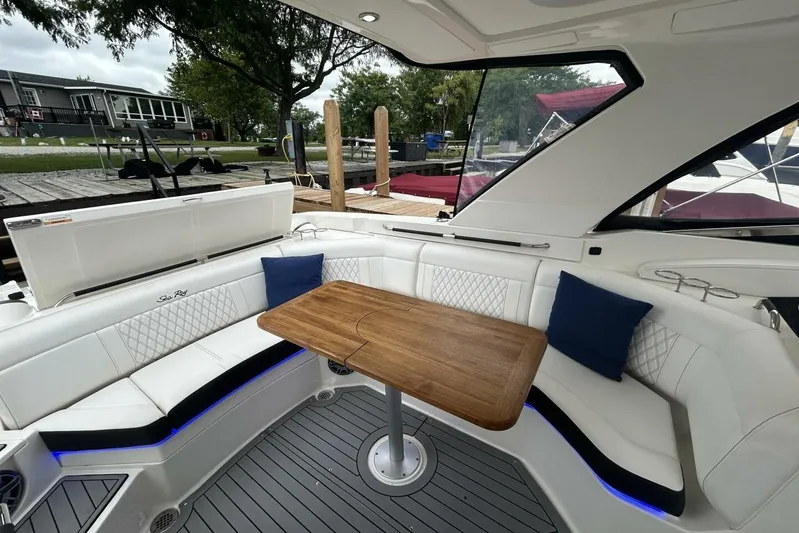  Yacht Photos Pics 2020 Sea Ray 350 SLX boat interior with white seating and wooden table.