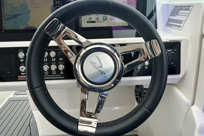  Yacht Photos Pics Steering wheel of 2020 Sea Ray 350 SLX boat with control panel and display.