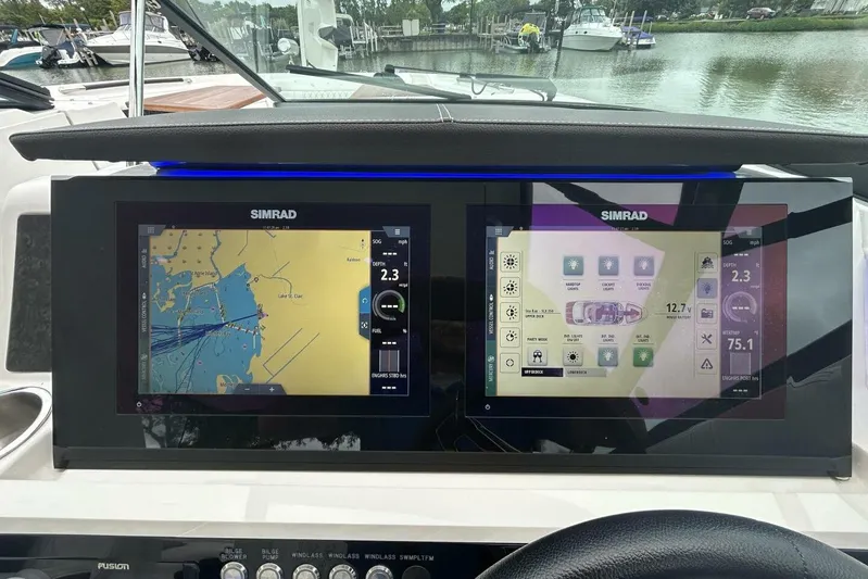  Yacht Photos Pics Simrad navigation screens on 2020 Sea Ray 350 SLX boat dashboard, displaying maps and controls.