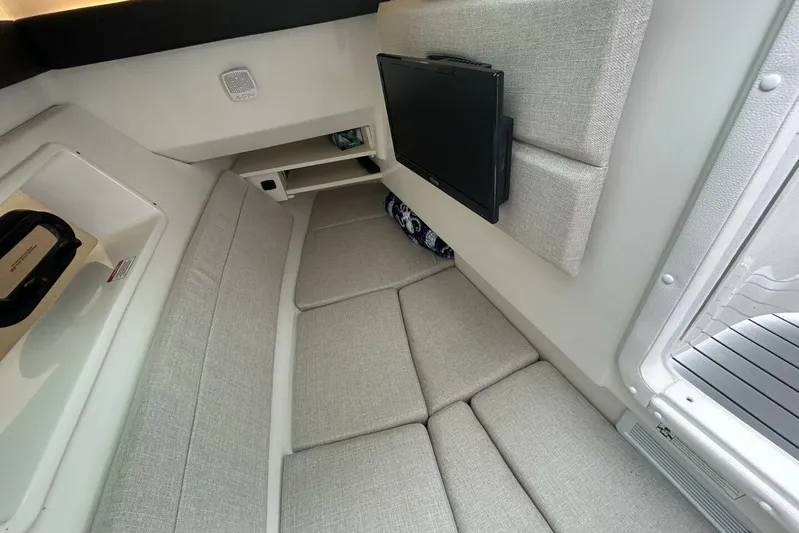  Yacht Photos Pics Interior cabin of 2020 Sea Ray 350 SLX with cushioned seating and mounted TV.