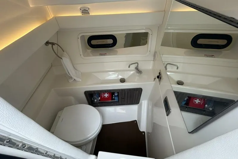  Yacht Photos Pics 2020 Sea Ray 350 SLX boat bathroom with sink, toilet, and first aid kit.