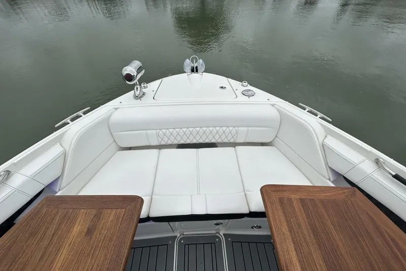  Yacht Photos Pics 2020 Sea Ray 350 SLX boat interior with white seating and wooden tables on calm water.