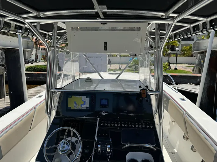  Yacht Photos Pics 2008 Fountain 38 TE boat cockpit with navigation system and steering wheel.