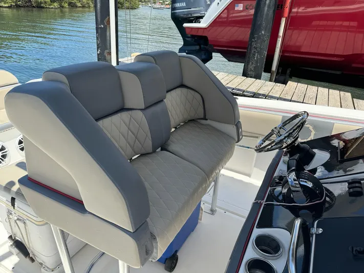  Yacht Photos Pics 2008 Fountain 38 TE boat interior with gray cushioned seating and steering console.