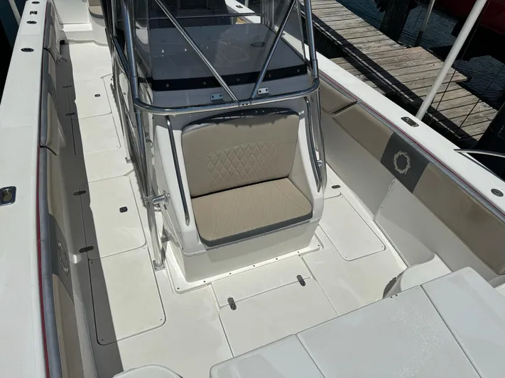  Yacht Photos Pics 2008 Fountain 38 TE boat interior with seating and console, docked at marina.