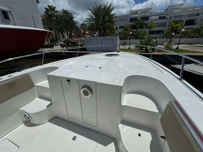  Yacht Photos Pics 2008 Fountain 38 TE boat deck with seating, docked near palm trees and modern buildings.