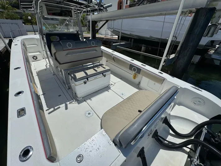  Yacht Photos Pics 2008 Fountain 38 TE boat interior with seating and storage, docked at marina.