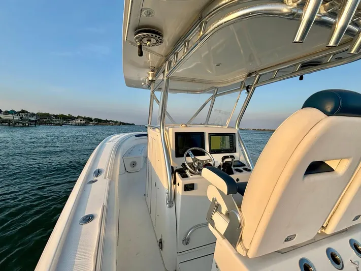  Yacht Photos Pics 2013 Buddy Davis 34 Center Console boat on calm water, featuring helm and seating area.