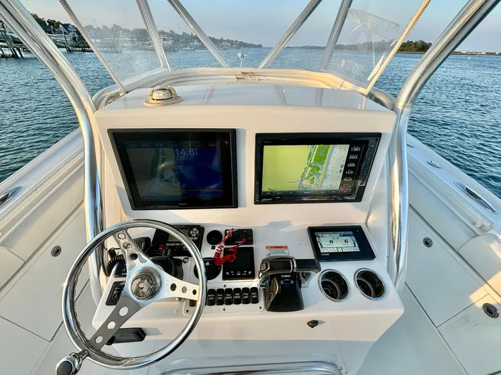  Yacht Photos Pics 2013 Buddy Davis 34 Center Console helm with dual displays and steering wheel on open water.