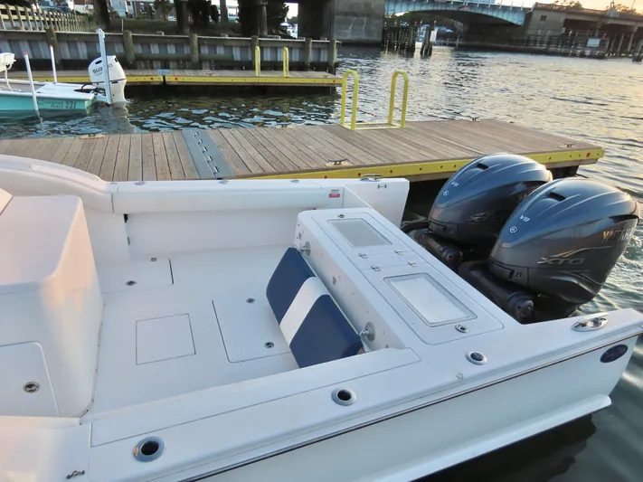  Yacht Photos Pics 2013 Buddy Davis 34 Center Console boat with dual engines docked by a wooden pier.