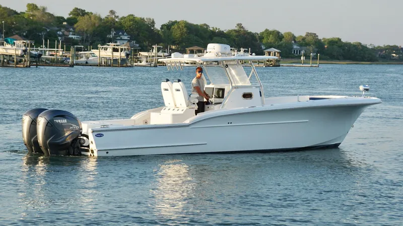  Yacht Photos Pics 2013 Buddy Davis 34 Center Console boat on calm water with twin Yamaha engines.