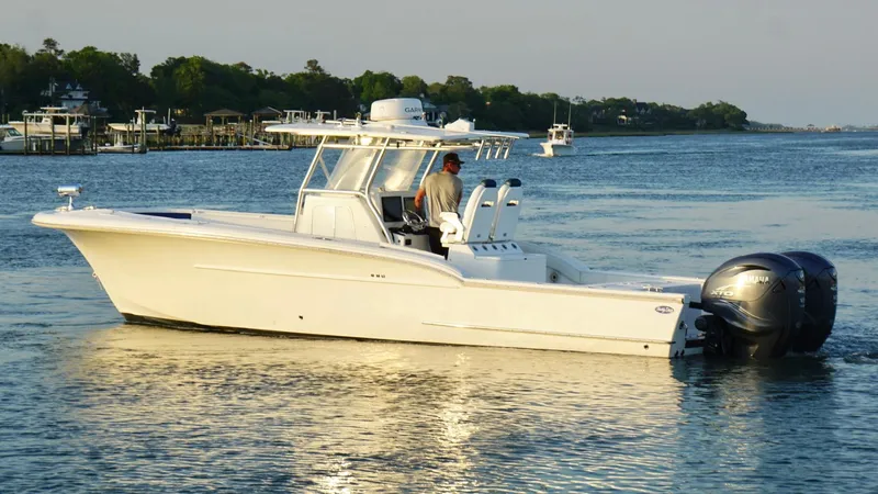  Yacht Photos Pics 2013 Buddy Davis 34 Center Console boat cruising on calm water.
