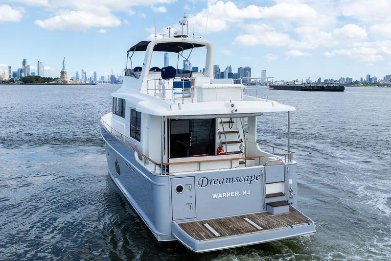 Dreamscape Yacht Photos Pics 2020 Beneteau Swift Trawler 50 cruising near Statue of Liberty, New York City skyline in background.