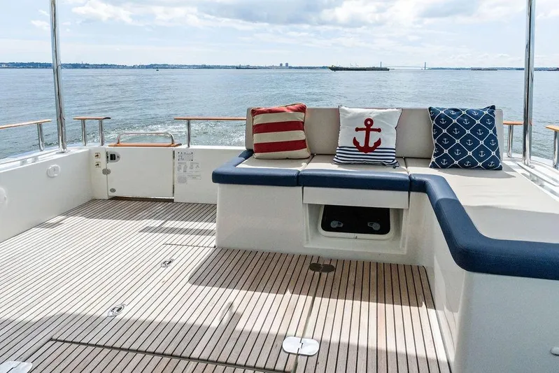 Dreamscape Yacht Photos Pics 2020 Beneteau Swift Trawler 50 deck with nautical-themed cushions and ocean view.