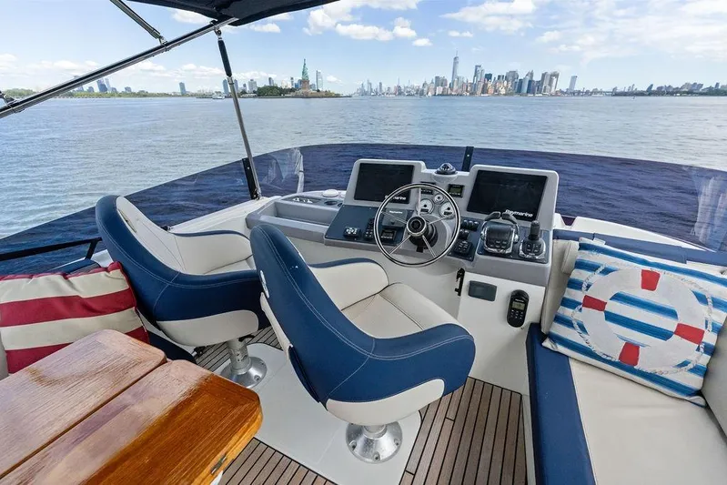 Dreamscape Yacht Photos Pics Beneteau Swift Trawler 50 helm with city skyline view, 2020 model.
