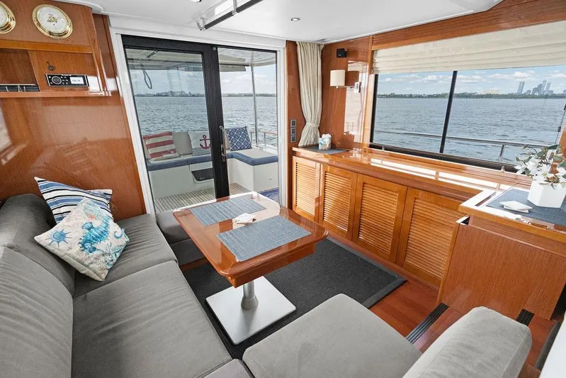 Dreamscape Yacht Photos Pics Interior of 2020 Beneteau Swift Trawler 50 with elegant wood finish and waterfront view.