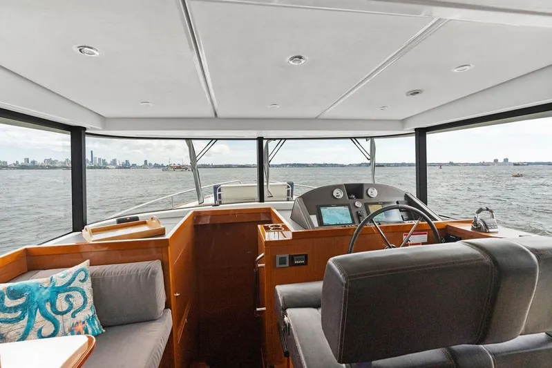 Dreamscape Yacht Photos Pics Interior view of 2020 Beneteau Swift Trawler 50 helm with panoramic water views.