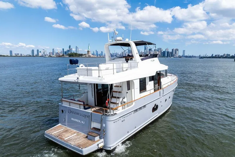 Dreamscape Yacht Photos Pics 2020 Beneteau Swift Trawler 50 cruising near city skyline and Statue of Liberty.