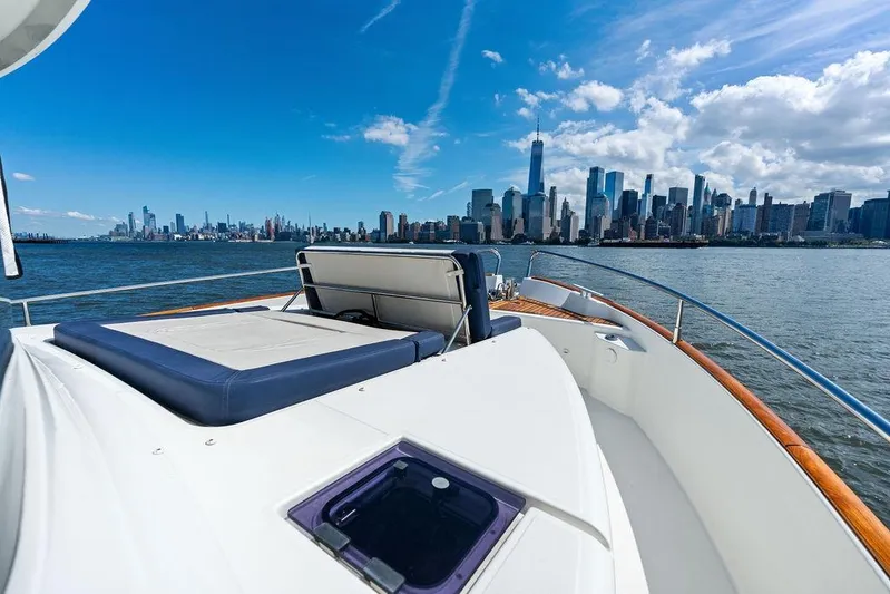 Dreamscape Yacht Photos Pics Beneteau Swift Trawler 50 cruising with city skyline in the background, 2020 model.
