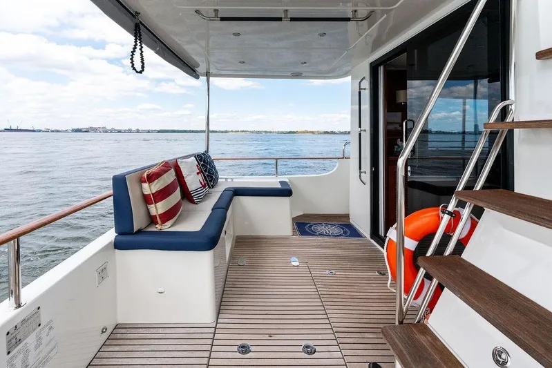 Dreamscape Yacht Photos Pics 2020 Beneteau Swift Trawler 50 deck with seating, ocean view, and life preserver.