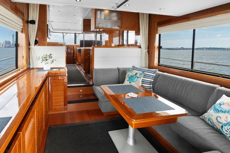 Dreamscape Yacht Photos Pics Luxurious interior of 2020 Beneteau Swift Trawler 50 with elegant wood finishes and waterfront view.