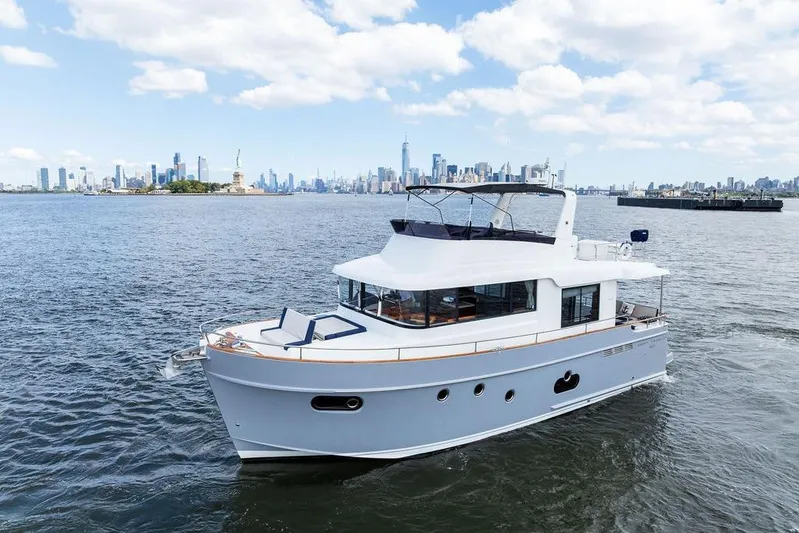 Dreamscape Yacht Photos Pics 2020 Beneteau Swift Trawler 50 cruising near city skyline and Statue of Liberty.