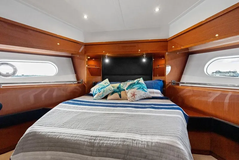 Dreamscape Yacht Photos Pics Luxurious cabin interior of 2020 Beneteau Swift Trawler 50 with cozy bedding.
