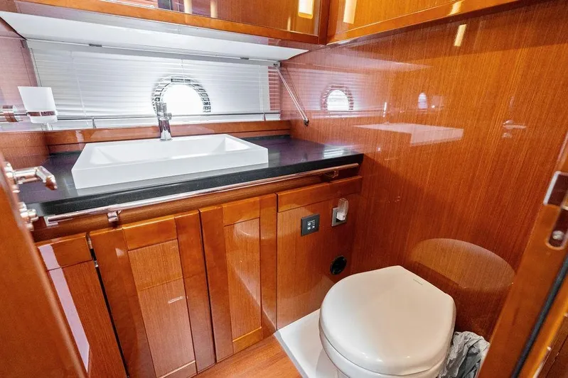 Dreamscape Yacht Photos Pics Luxurious bathroom in 2020 Beneteau Swift Trawler 50 with wood finish and modern fixtures.