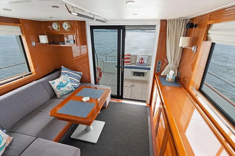 Dreamscape Yacht Photos Pics Interior of 2020 Beneteau Swift Trawler 50 with elegant wood finish and cozy seating.