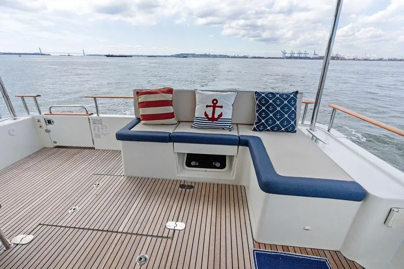 Dreamscape Yacht Photos Pics Beneteau Swift Trawler 50, 2020 model, featuring a stylish deck with nautical-themed cushions.