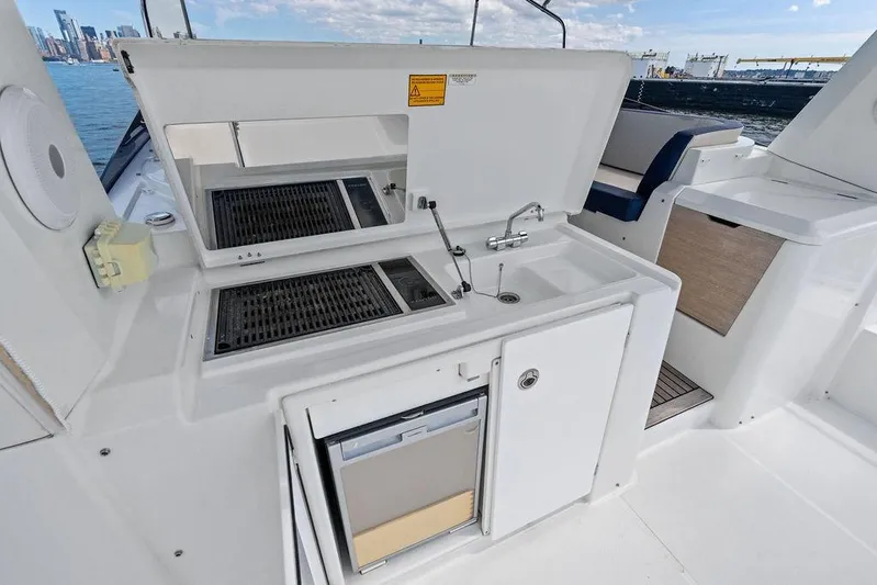 Dreamscape Yacht Photos Pics Outdoor kitchen on 2020 Beneteau Swift Trawler 50, featuring grill and sink.
