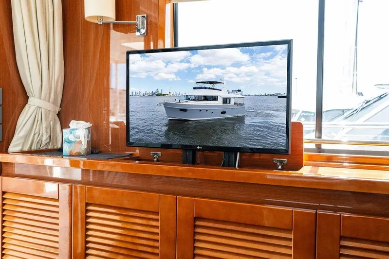 Dreamscape Yacht Photos Pics Television displaying a 2020 Beneteau Swift Trawler 50 yacht in a luxurious cabin setting.