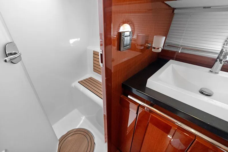 Dreamscape Yacht Photos Pics 2020 Beneteau Swift Trawler 50 bathroom with sleek sink and wooden accents.